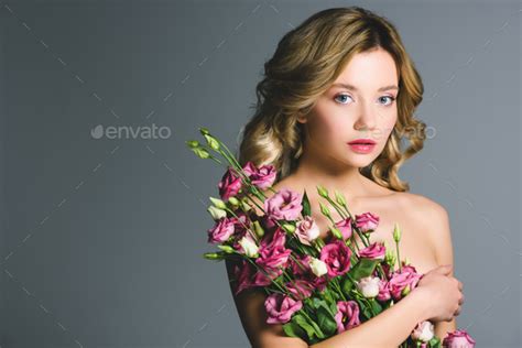 Attractive Naked Woman Holding Bouquet Of Eustoma Flowers Isolated On