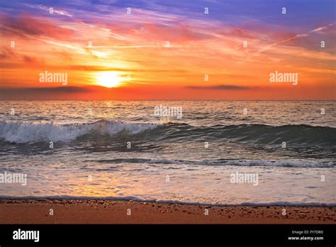 Colorful Ocean Beach Sunrise With Deep Blue Sky Stock Photo Alamy