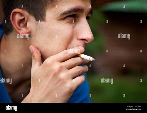 Sad Young Man Smoking Cigarette Outdoor Closeup Stock Photo Alamy