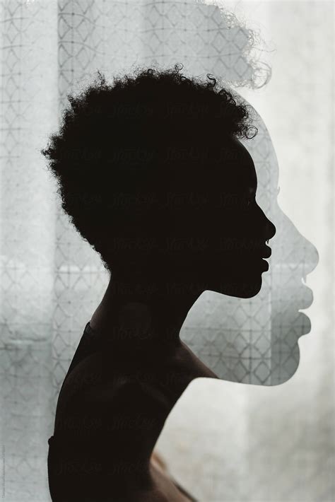 A Young African American Woman In Silhouette By Stocksy Contributor