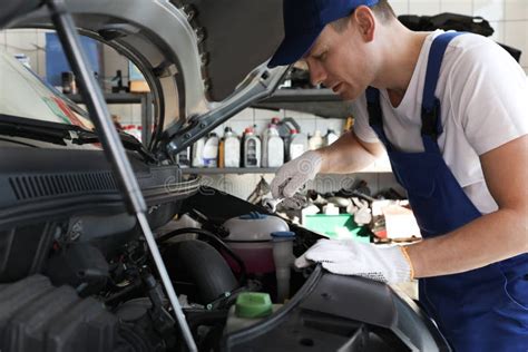 Professional Auto Mechanic Fixing Car In Service Center Stock Image