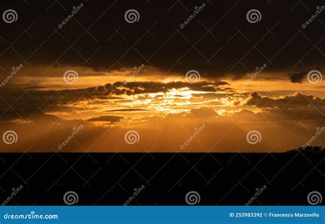 Sunset Between Golden Sunset Clouds Silhouette Stock Photo Image Of