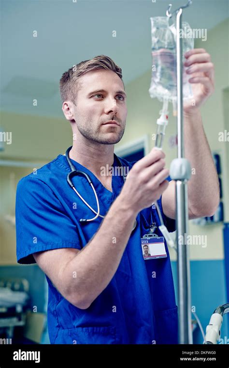 Doctor Adjusting Intravenous Drip In Hospital Stock Photo Alamy