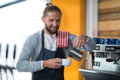 Premium Photo Portrait Of Smiling Waiter Making Cup Of Coffee