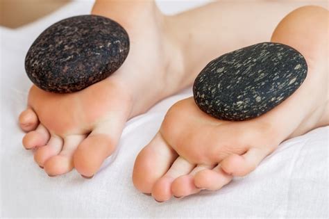 Premium Photo Hot Stone Feet Massage