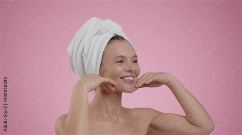 Facebuilding Concept Semi Profile Portrait Of Middle Aged Woman With Towel On Head Doing Face
