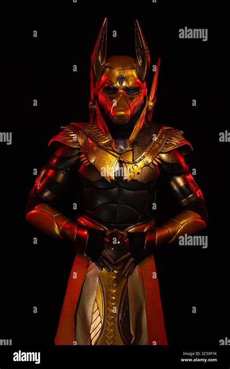 a male actor in a suit of an egyptian mythology character the golden deity jackal anubis
