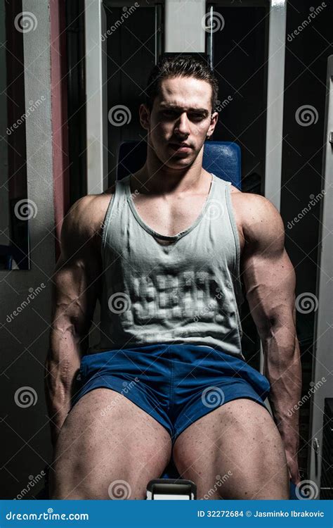 Bodybuilder Doing Heavy Weight Exercise For Legs On Machine Leg