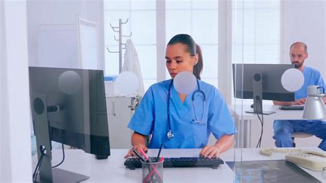 Woman Receptionist Answering At Phone Working In Hospital Clinic