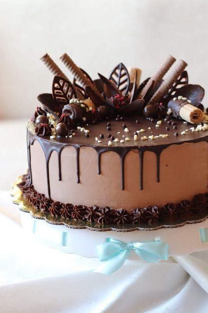 A Cake With Chocolate Icing And Candies On Top