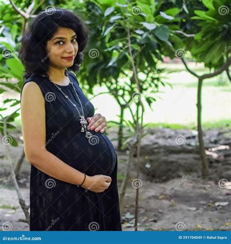 A Pregnant Indian Lady Poses For Outdoor Pregnancy Shoot And Hands On