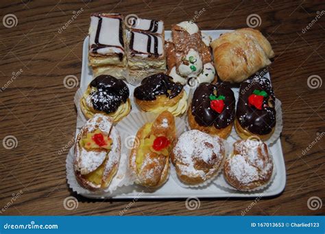 fresh baked italian and french pastries in a white dish on a wood table stock image image of