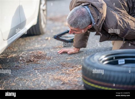 Person Changing Flat Tyre Hi Res Stock Photography And Images Alamy