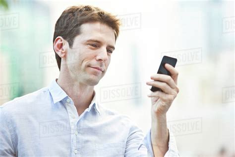 Mid Adult Man Checking Cell Phone Stock Photo Dissolve