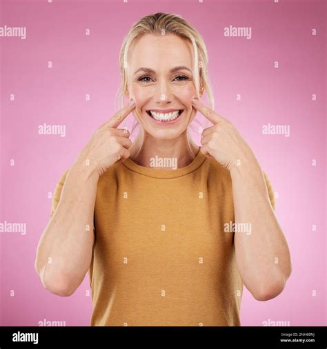 Teeth Whitening Portrait And Pointing Woman In Studio Pink Background