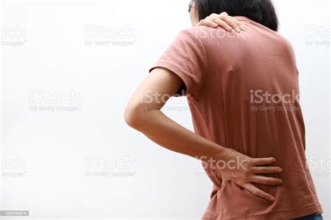 Women With Shoulder And Back Pain Against White Background Stock Photo