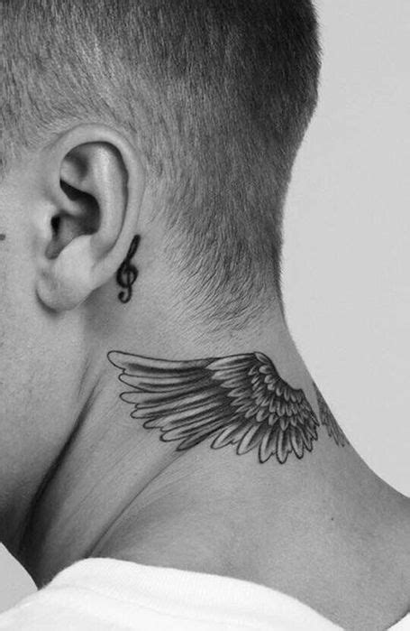 A Man With A Tattoo On His Neck And Behind The Ear Is An Angel Wing