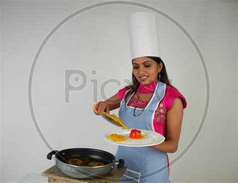 Image Of An Indian Woman Cooking Jalebi Or Jilebi Sweet On An Isolated White Background Au436657