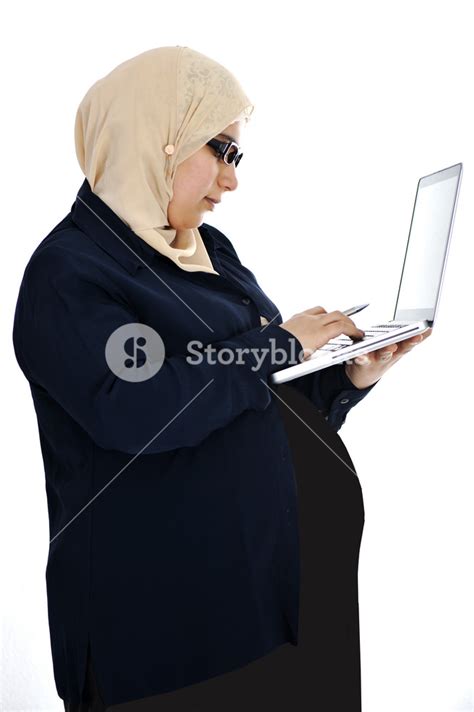 Pregnant Muslim Arabic Woman Using Laptop Royalty Free Stock Image