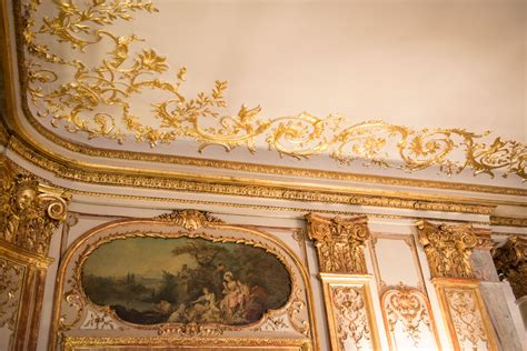 An Ornately Decorated Room With Paintings On The Walls