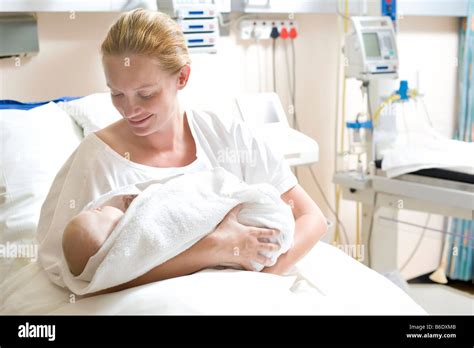 Mother And Newborn Baby Woman In A Maternity Ward Holding Her Newborn