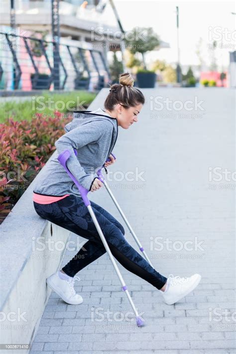 Young Beautiful Woman With Crutches Stock Photo Download Image Now