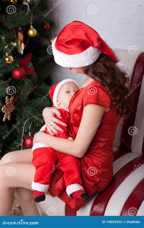 Mother Breast Feeding Baby In Santa S Costumes Stock Photo Image Of