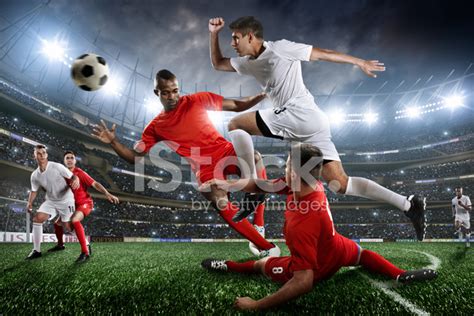 Soccer Players In Action On Soccer Stadium Stock Photos