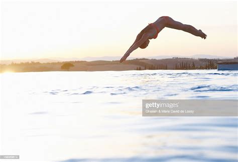 Woman Diving Into Swimming Pool Scenery High Res Stock Photo Getty Images