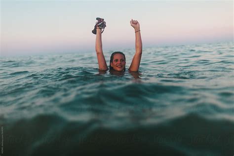 Young Woman Swims Naked In The Ocean Surf By Stocksy Contributor Howl Stocksy