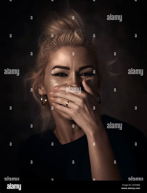 Portrait Of A Blonde Woman Hiding Her Laugh Stock Photo Alamy