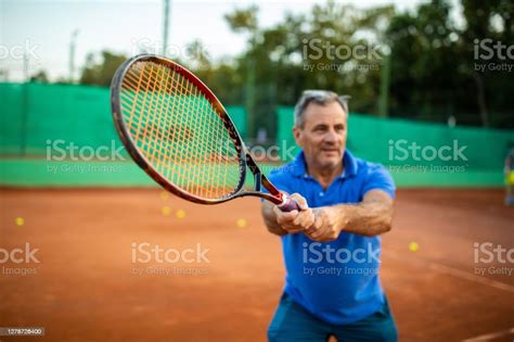 Senior Tennis Player Playing Tennis Stock Photo Download Image Now