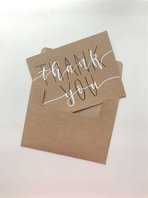 Two Brown Envelopes With Thank You Written On Them