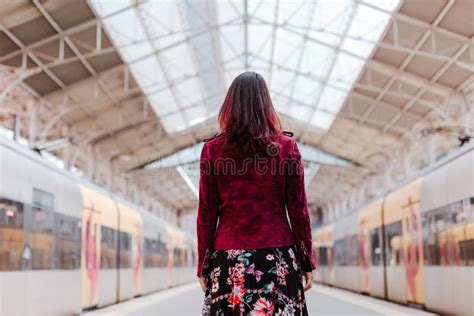 Back View Of Caucasian Woman In Train Station Waiting To Travel Travel And Lifestyle Concept