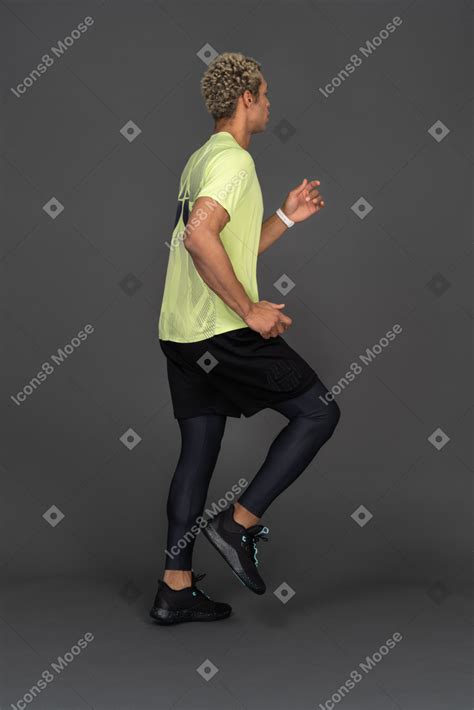 Side View Of A Running Dark Skinned Young Man Photo