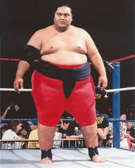 A Sumo Wrestler Standing In The Middle Of A Wrestling Ring With His