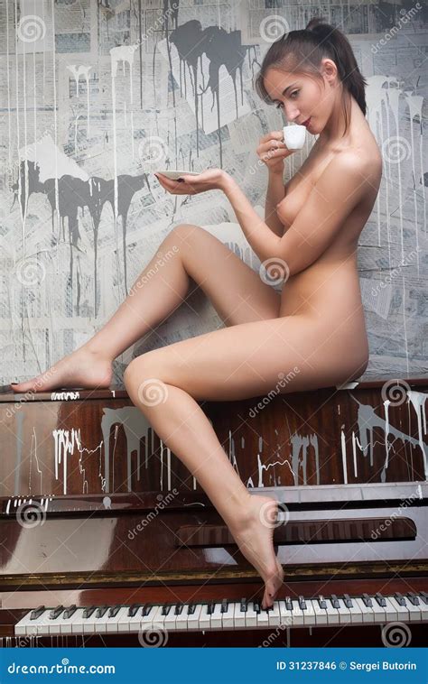 Attractive Nude Woman On Piano Drinking Coffee Stock Photo Image