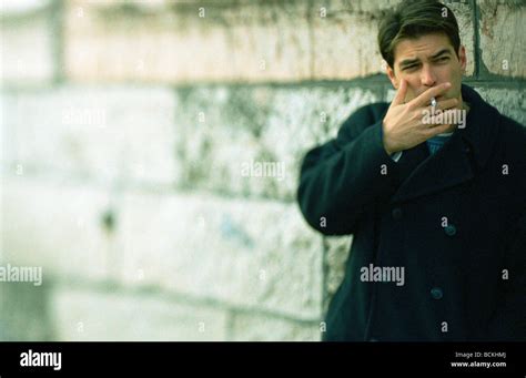 Man Leaning Against Wall Smoking Cigarette Hi Res Stock Photography And