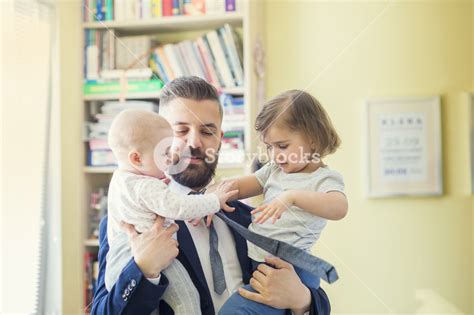 Young Father Hugging His Daughters As He Gets Home From Work Royalty Free Stock Image Storyblocks