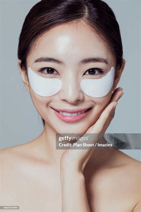 Woman Putting Eye Patch High Res Stock Photo Getty Images