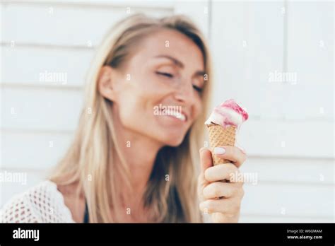Blonde Girl Eating Melting Ice Cream In A Cone Stock Photo Alamy
