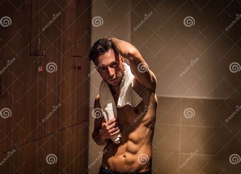 Shirtless Young Male Athlete In Gym Dressing Room With Towel Stock