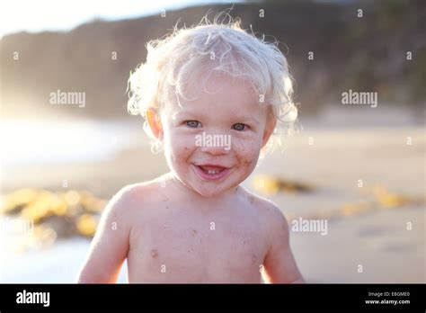 Smiling Boy Standing On Beach Stock Photo Alamy
