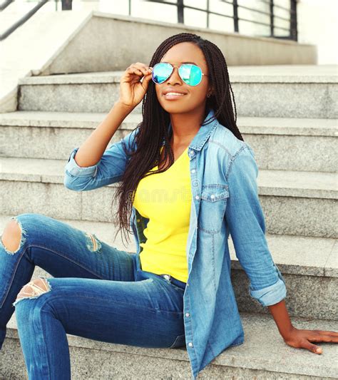 Fashion Beautiful Smiling African Woman Wearing A Sunglasses And Jeans