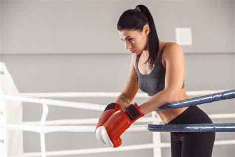 Boxing Woman In Gloves Boxer Leaning On Rope On Ring Looking Down