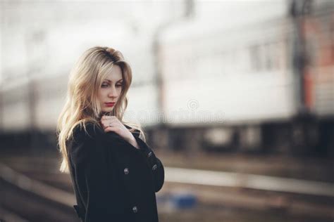 beautiful blonde girl waiting for the train at the station romantic delicate look stock image