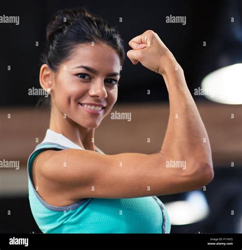 Smiling Beautiful Woman Showing Her Biceps In Gym Stock Photo Alamy
