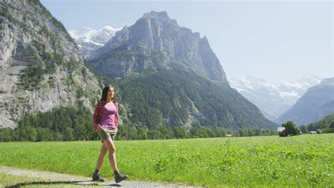 People Walking In Switzerland Alps Woman Hiker Tourist Hiking On Hike