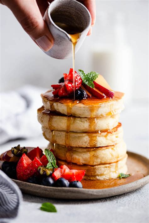 Maple Syrup Being Poured Over Fluffy Pancakes American Pancake Recipe