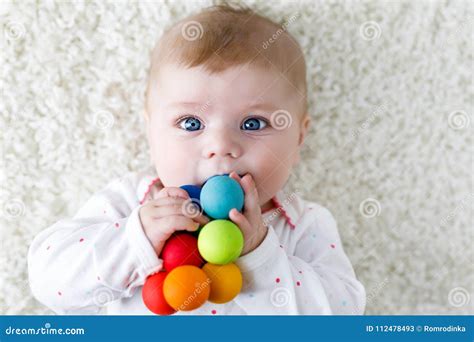 Cute Baby Girl Playing With Colorful Wooden Rattle Toy Stock Image